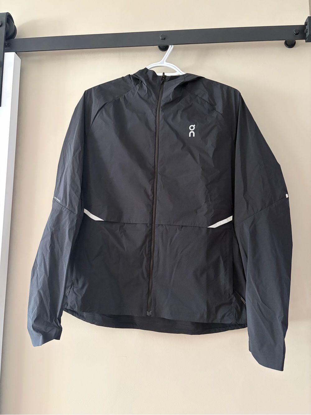 On Running Women’s Black Hooded Windbreaker with Reflective Accents